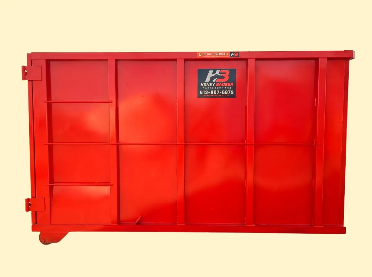 Exterior of a red Honey Badger 20 yard dumpster rental bin